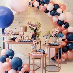 a table with balloons and desserts on it