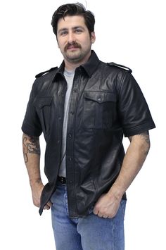 Men's short sleeve leather shirt in soft lambskin leather now with inside concealed carry pockets and more military uniform styling. A men's leather shirt has heavy duty snaps up font, epaulets on each shoulder and a leather shirt collar. This snap-up leather t shirt comes with two snap flap chest pockets, a long body that keeps the draft from up the back and a soft nylon lining. Keep cool and look dapper in this cool premium quality leather shirt exclusively from Jamin Leather. This shirt is ideal for TALL men as well. Sizes: S, M, L, XL, 2X, 3X. +$10 for 2X-3X. [4#] MS2300K military uniform styling dual inside concealed pockets short sleeve snap front snap flap chest pockets soft nylon lining top grain leather soft lambskin leather Jamin Leather® Exclusive IMPORTANT SPECIFICATIONS: EXCLU Classic Collared Leather Shirt, Leather Button-up Top With Pockets, Leather Collared Top With Pockets, Uniform Styling, Mens Leather Shirt, Leather T Shirt, Uniform Shirt, Tall Men, Uniform Shirts