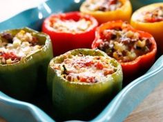 several stuffed peppers are in a blue dish