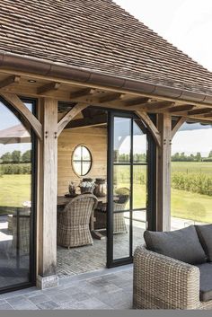 an outdoor living room with sliding glass doors