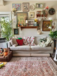 a living room filled with furniture and lots of pictures on the wall above it's couch