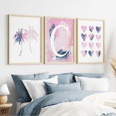 two framed pictures hang on the wall above a bed with blue sheets and white pillows