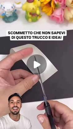 a man is cutting paper with scissors in front of him and the caption reads, someone