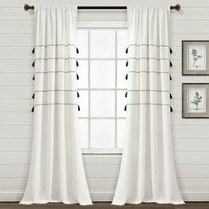 white curtains with black piping in front of a window