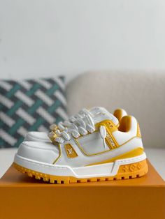 Unleash your inner athlete with these LV Trainer Maxi-inspired sneakers in a striking white and yellow colorway. This bold design, inspired by Louis Vuitton's iconic silhouette, features an exaggerated sole and eye-catching accents, creating a playful and fashion-forward look. Crafted with meticulous attention to detail, these sneakers offer a premium blend of comfort and luxury, perfect for those who dare to stand out. Your order arrives in a branded shoe box, complete with dust bags, extra lac Louis Vuitton Trainer, Louis Vuitton Trainers, Fall Winter Jacket, Yellow Maxi, Loafer Sneakers, Bottega Veneta Shoulder Bag, Key Holder, Shoe Box, Loafer Shoes