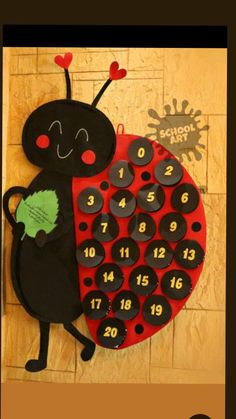 a ladybug shaped clock on the wall with numbers for each month in it