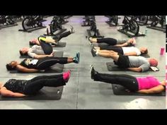 people doing exercises on exercise mats in a gym