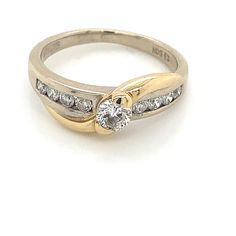 a gold and diamond ring on a white background