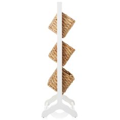 three wicker baskets stacked on top of each other in a white stand against a white background