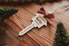 a wooden ornament with a ribbon tied around it on top of a table