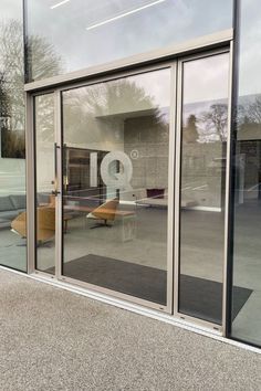 an office building with glass doors and chairs