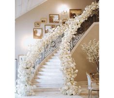 a staircase with white flowers and chandelier