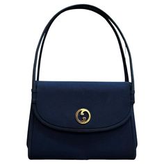 This vintage GUCCI small handbag is crafted of polyester fabric in navy featuring gold-toned hardware. Front flap magnatic snap closure opens to a navy satin interior featuring a patch pocket. This vintage Gucci is the perfect evening clutch for your night out essentials. Made in Italy. Measures approximately 8 x 6.5 x 1.5 inches. Condition - Very good vintage condition with minor signs of wear Outside: Very minor marks Inside: Minimal to no visible signs of wear Smell: No odor Vintage Gucci Bag With Removable Pouch, Vintage Gucci Evening Bags, Vintage Gucci Shoulder Bag With Removable Pouch, Gucci Blue Shoulder Bag With Removable Pouch, Gucci Formal Satchel With Removable Pouch, Gucci Satchel With Removable Pouch For Formal Occasions, Gucci Evening Bag With Removable Pouch, Gucci Rectangular Satchel For Evening, Gucci Rectangular Evening Satchel