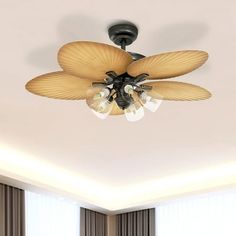 a ceiling fan with three lights in a room