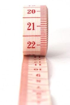 a measuring tape with the numbers twenty two and twenty three on it's side