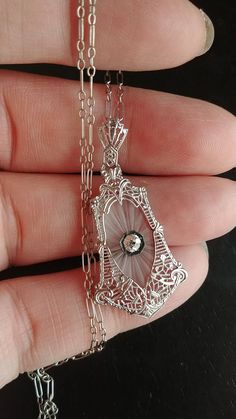 Stunning Art Deco Necklace, Pendant and Original Chain, made from 14k White Gold, approximately 0.15ct Old Mine Cut Diamond, Camphor Glass, Filigree design... Diamond is approximately 0.15ct, VS, GH.. Perfect Antique Condition. All sales are final. Weight is 4.1 Grams. Layaway plan is Available.. Some pics Enlarged to see details. Camphor Glass Jewelry, Nouveau Jewelry, Old Mine Cut Diamond, Filigree Necklaces, Retro Ring, Art Deco Necklace, Art Nouveau Jewelry, Filigree Design, Deco Jewelry