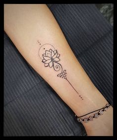 a woman's arm with a tattoo on it and a flower in the middle