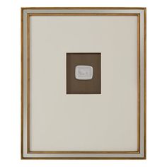 a white and gold frame with a square shaped object in the center