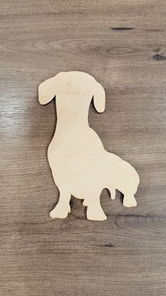 a wooden dog ornament sitting on top of a table