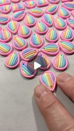 a hand is pointing at some colorful buttons