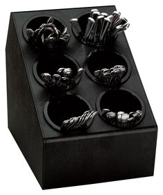 a black display case with six silver objects in it