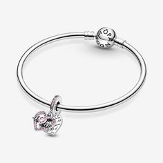 Surprise her with the Heart & Mom Dangle Charm. Hand-finished in sterling silver, the heart-shaped front disc is outlined with pink crystals and features “Mom” script with the “U” replaced by a heart set with a matching stone. The engraving “All of me loves all of you” features on the back heart-shaped disc in a repeating pattern. A row of pink sparkling stones features on the bail. Put a smile on your mom's face with this colorful design. - Pandora Heart & Mom Dangle Charm - Sterling silver / Mixed stone / Pink Pandora Pink Heart Charm, Sterling Silver Pink Charm Bracelet With Dangling Charms, Pink Sterling Silver Dangle Charms, Pandora Heart Dangle Charm, Pink Heart-shaped Sterling Silver Charms, Pandora Heart, Pandora Hearts, New Heart, Mesh Bracelet