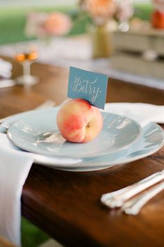 a plate with an apple on it sitting on a table