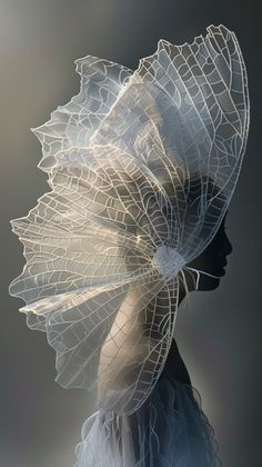 a woman's head is covered in white netting