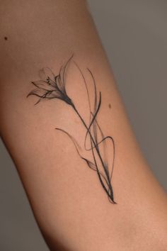 a woman's arm with a tattoo on it that has a flower in the middle