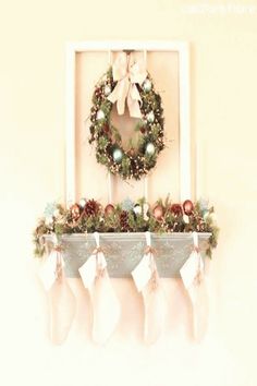 christmas stockings hanging on the mantle with a wreath and stocking