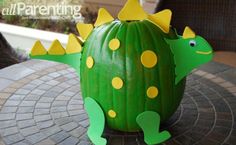 an inflatable green cactus with yellow dots on it's head and tail