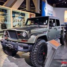 the jeep is on display at the showroom for people to see and take pictures