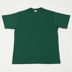 They don't come more iconic than the 1950's pocket tee, and Warehouse & Co Japan have produced one to rival all others. This circular knit tee is woven from a luxuriously soft 100% cotton and boasts a traditional boxy shape. The brand has chosen only the finest cotton to go into their tees, the integrity of which, blended with the traditional knitting style ensures that this garment will maintain its shape for the duration of its lifespan. The traditional loopwheel method of fabric production is Cotton T-shirt With Patch Pockets Relaxed Fit, Relaxed Fit Cotton T-shirt With Chest Pocket, Green Boxy Fit Cotton T-shirt, Cotton T-shirt With Patch Pockets, Short Sleeve, Green Relaxed Fit T-shirt With Pockets, Basic Shorts, Knit Tees, Pocket Tee, Clothing Co