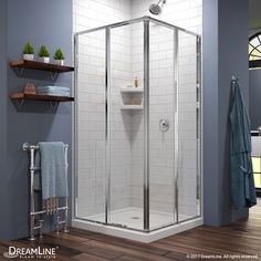 a walk in shower sitting on top of a wooden floor