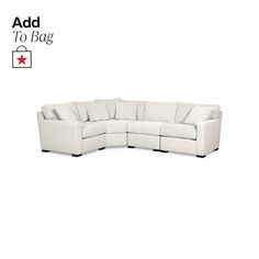 a white sectional couch sitting on top of a white floor next to a red star