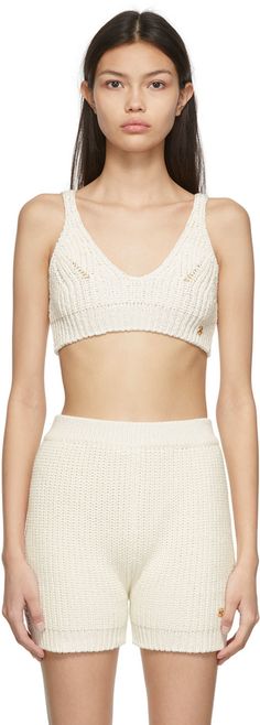 Sleeveless textured knit cotton-blend bralette-style tank top in off-white. · V-neck collar · Logo hardware in gold-tone at front · Rib knit cropped hem · Self-tie fastening at back Supplier color: Off-white | Recto Off-White Tape Yarn Beach Tank Top Knit Cropped Crop Top For Beach, Chic Knit Crop Top For Vacation, Beach Tanks Tops, White Tape, Beach Tanks, Bralette Crop Top, Textured Knit, Cami Tanks, Black Sleeveless