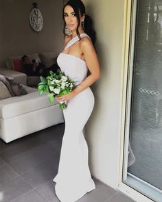 a woman in a white dress holding a bouquet