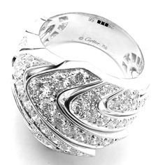 This Cartier ring is a luxurious 18k white gold piece, featuring an elegant wave design studded with sparkling diamonds. The undulating form of the ring mimics the serene movement of the ocean, while the diamonds add a sophisticated glimmer, reflecting Cartier's hallmark of timeless elegance and craftsmanship.This ring comes with original Cartier box. Metal: 18k White Gold Ring Size: European 58, US 8 1/4 Stones: 86 Round brilliant cut diamonds VVS1 clarity, E color total weight approximately 4. Cartier Diamond Ring Brilliant Cut, Cartier Fine Jewelry Diamond Ring With Brilliant Cut, Cartier Brilliant Cut Diamond Ring, Cartier Diamond Ring With Brilliant Cut, Cartier Luxury Diamond White Diamond Ring, Cartier Platinum Diamond Ring With Prong Setting, Luxury White Diamond Ring With Pave Setting, Cartier Platinum Ring In Diamond White, Cartier Diamond White Brilliant Cut Diamond Ring