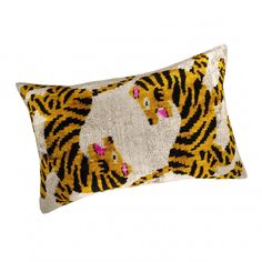 a pillow with a tiger pattern on it's side and a pink eye patch in the middle