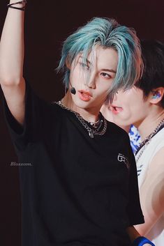 two young men with blue hair and piercings