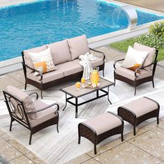 an outdoor patio furniture set near a swimming pool