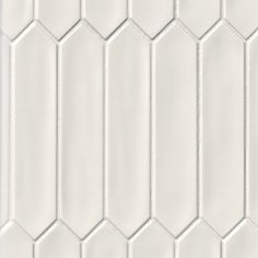 white hexagonal tiles are arranged in rows and diagonals to create a geometric pattern