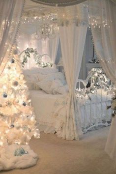 a bedroom decorated for christmas with a white tree