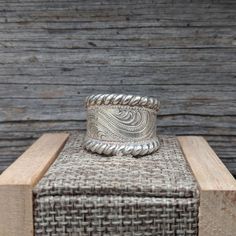 "Beautiful tapered sterling silver hand-engraved ring with silver \"rope\" edge, hand made with love in Eminence Missouri by western designer and engraver Ryan Liggett. Individual pieces may vary slightly from the pictured item. We make each piece by hand, one at a time, for every order. Because of this your final piece may vary slightly from the picture and engraving style may be adjusted slightly to fit your ring size or customizations. Please allow at least 1 to 2 weeks for shipment. Details: Handmade Silver Western Style Rings, Handmade Western Silver Rings, Southwestern Engraved Rings For Anniversary, Western Style Stamped 925 Rings As Gift, Western Style 925 Silver Rings As Gifts, Eminence Missouri, Western Ring, Western Rings, Engraved Ring