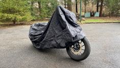 the motorcycle is covered with a black cover