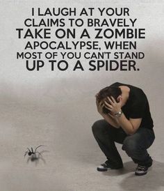 a man kneeling down in front of a spider on the ground with his hands to his face