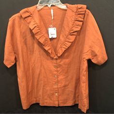 Free People Peach Colored Ruffled Neckline Top Size Xs Nwt. 23” Collar To Hem, 22” Pit To Pit. Orange Short Sleeve Blouse With Ruffles, Orange Ruffled Short Sleeve Blouse, Orange Ruffled Summer Top, Summer Orange Ruffle Tops, Summer Orange Ruffled Tops, Chic Orange Ruffled Top, Trendy Ruffled Collar Top, Summer Tops With Ruffled Collar And Hem, Summer Tops With Ruffle Hem And Ruffled Collar