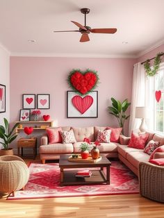 a living room with pink walls and red pillows on the couches in front of two windows