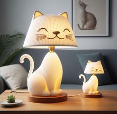 a cat lamp sitting on top of a table next to a white cat figurine