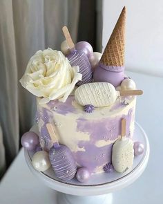 there is a cake that has ice cream on it and decorations around the top layer